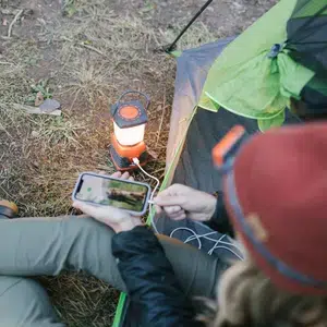 Camp_Lantern_Recharge_woman_charging_phone_with_lantern