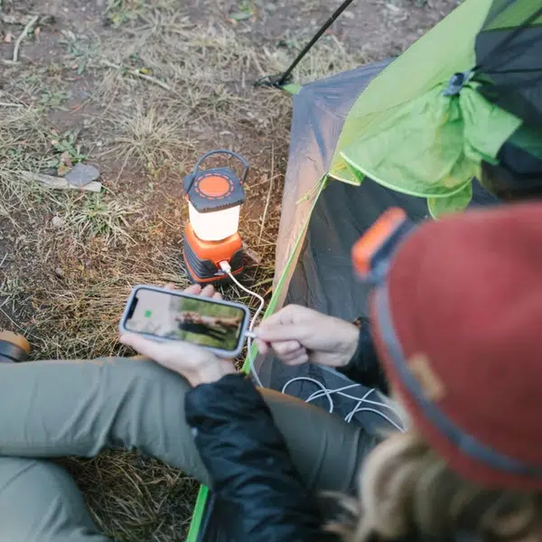 Camp_Lantern_Recharge_woman_charging_phone_with_lantern