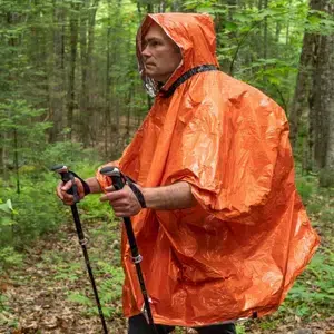 Heat_Reflective_Poncho_in_use_man_backpacking